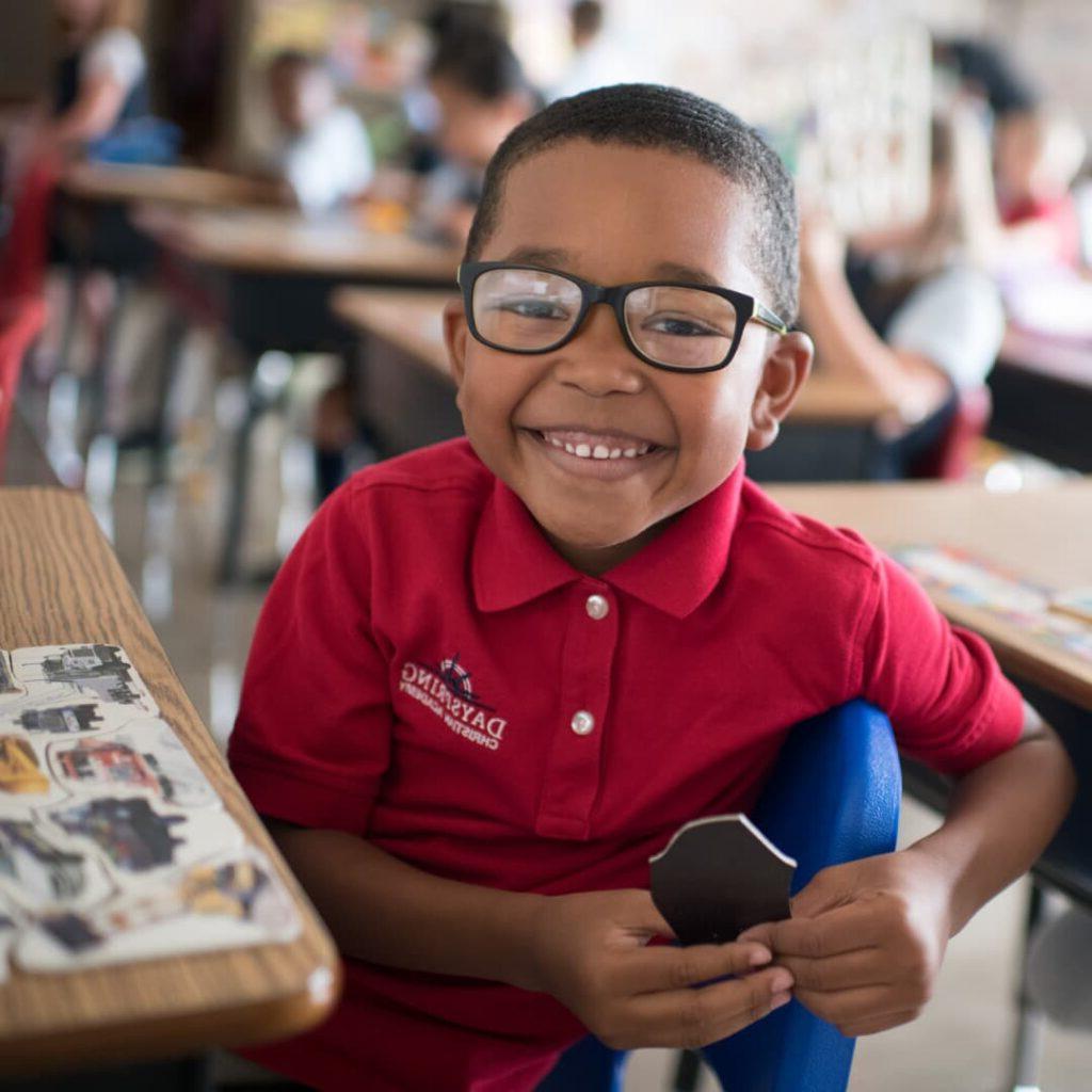 A smiling kindergarten student at 黎明 Christian Academy in Lancaster, PA